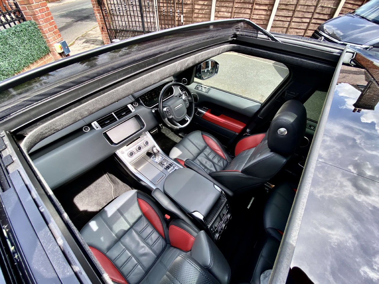 Completed interior car valet service viewed through sunroof of Range Rover